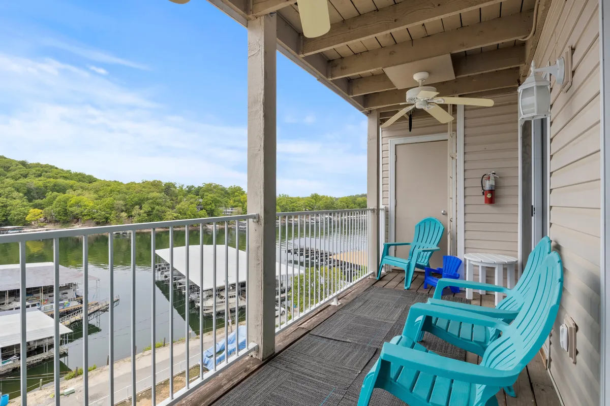 A peaceful balcony scene with Adirondack chairs perfectly positioned to enjoy sunset views over the lake. The calm water and surrounding wildlife invite moments of stargazing, conversation, and soaking in the natural ambiance.